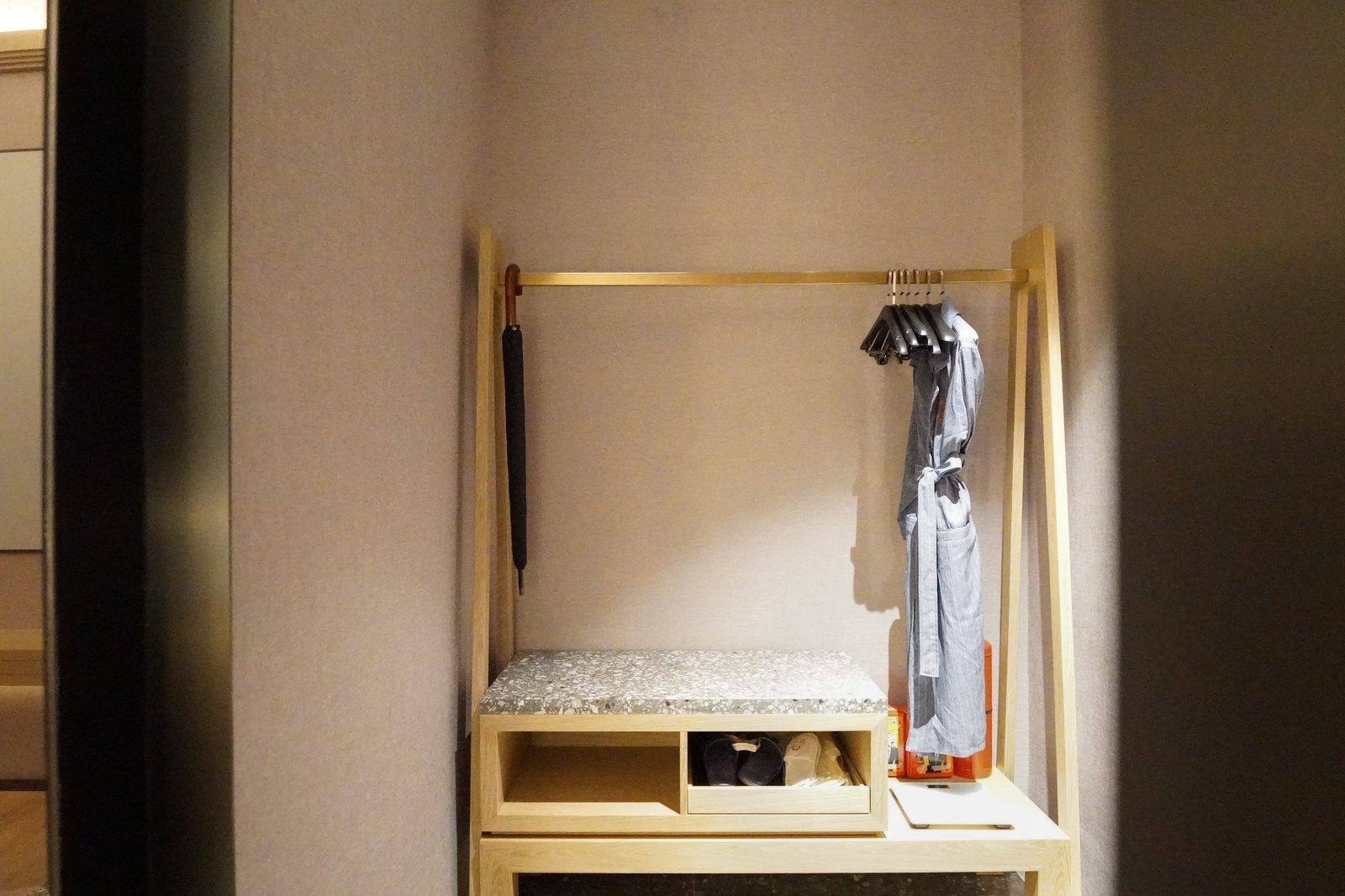 A small, enclosed room with a bunk bed, a wooden bench, and a small storage space.