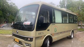 A bus with a front license plate, side text, and a logo on the side.