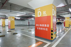A parking garage with multiple D zone signs and a B2 level sign.