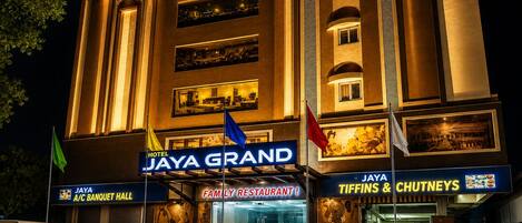 A hotel with a prominent sign for 'JAYA GRAND' and a family restaurant.