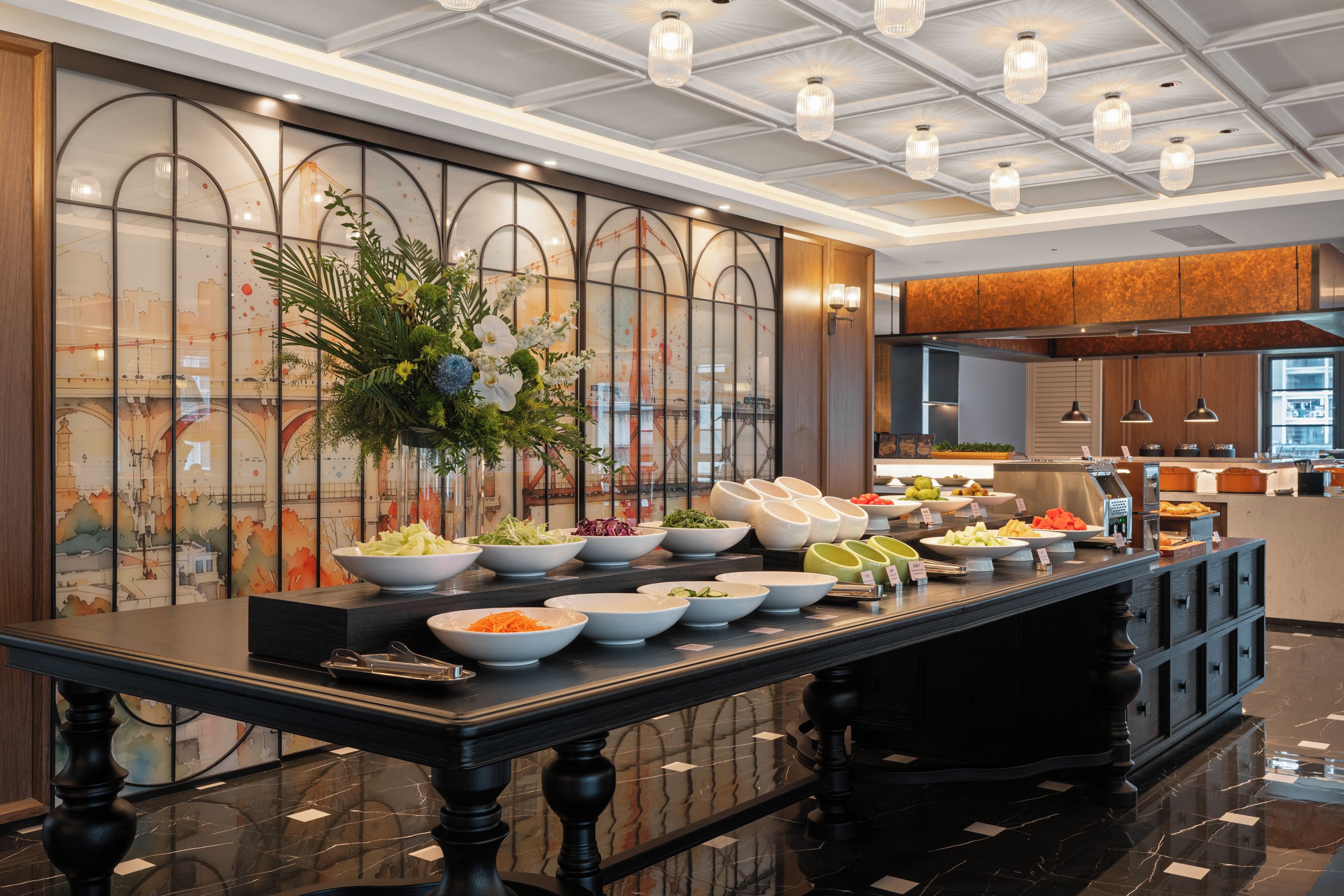 A buffet setup with various food items and a decorative centerpiece.