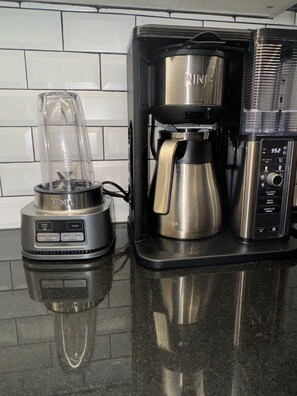 A kitchen with a coffee maker and a blender on the counter. - Delightful 2-bedroom apartment with AC in vibrant Brooklyn (Brooklyn)