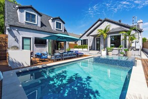 A residential property with a swimming pool, outdoor seating, and a covered patio area. - Pool + Hot Tub + Firepit + BBQ | Walk to Melrose + The Grove | Crescent Peak (West Hollywood)