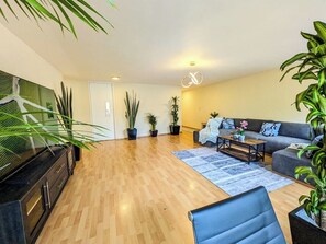A modern living room with a sofa, coffee table, and potted plants. - Big, Bright & Central Polanco 5BR, Sleeps 17! (Mexico City)