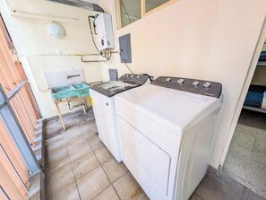 A compact kitchen with a washing machine, a small table, and a window. - Big, Bright & Central Polanco 5BR, Sleeps 17! (Mexico City)