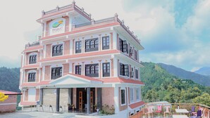 A multi-story building with a sign reading 'Thumki Resort-Balhali'. - Thumki Resort (Panaoti)
