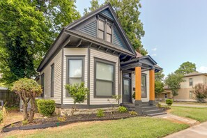 A two-story house with a gabled roof, large windows, and a front porch with steps. - Walk Everywhere! Downtown Fort Smith Duplex (Fort Smith)