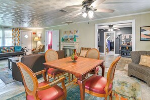 A spacious living room with a dining area, a fireplace, and a kitchen visible through an open doorway. - Wraparound Porch! Quiet Country Home, 9 Mi to MSU (Starkville)