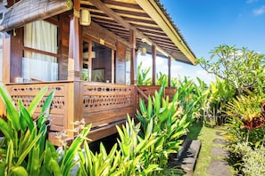 A wooden structure with a balcony, surrounded by lush greenery. - Moonloka Eskabbe Maha Villa (Gianyar)