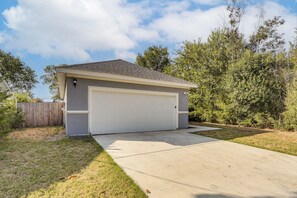 A single-story house with a garage, a fenced yard, and a clear sky. - Walk to Parks & Dining! Universal City Home (Universal City)
