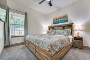 A bedroom with a bed, a nightstand, a lamp, a ceiling fan, and a window with curtains. - Walk to Parks & Dining! Universal City Home (Universal City)