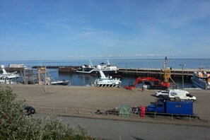 A marina with boats docked, a crane, and a blue container. - Holiday apartment with 2 bedrooms (Hörnum \/ Sylt)
