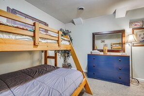 A bunk bed with a lower bunk, a dresser with drawers, a mirror, and a lamp. - Hot Tub Ski Home: Rooster's Den in Ellicottville (Ellicottville)