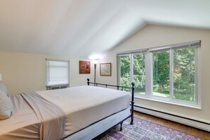A bedroom with a bed, a window, and a radiator. - Historic Streamside Farmhouse in Stroudsburg! (Stroudsburg)