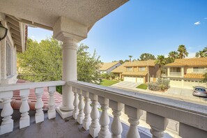 A balcony with a view of a residential street, a clear sky, and a well-maintained lawn. - Extended-Stay Vegas Retreat w/ Private Pool & Spa (Las Vegas)