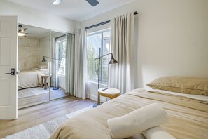 A bedroom with a large mirror, a bed with pillows, a small round table, and a standing lamp. - Extended-Stay Vegas Retreat w/ Private Pool & Spa (Las Vegas)