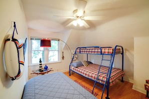 A room with a bunk bed, a desk with a lamp, a window, and a ceiling fan. - Shared Deck w/ Lake Views! St Joseph Upstairs Apt (St Joseph)