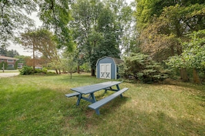 A picnic table in a grassy area with a shed in the background. - Shared Deck w/ Lake Views! St Joseph Upstairs Apt (St Joseph)