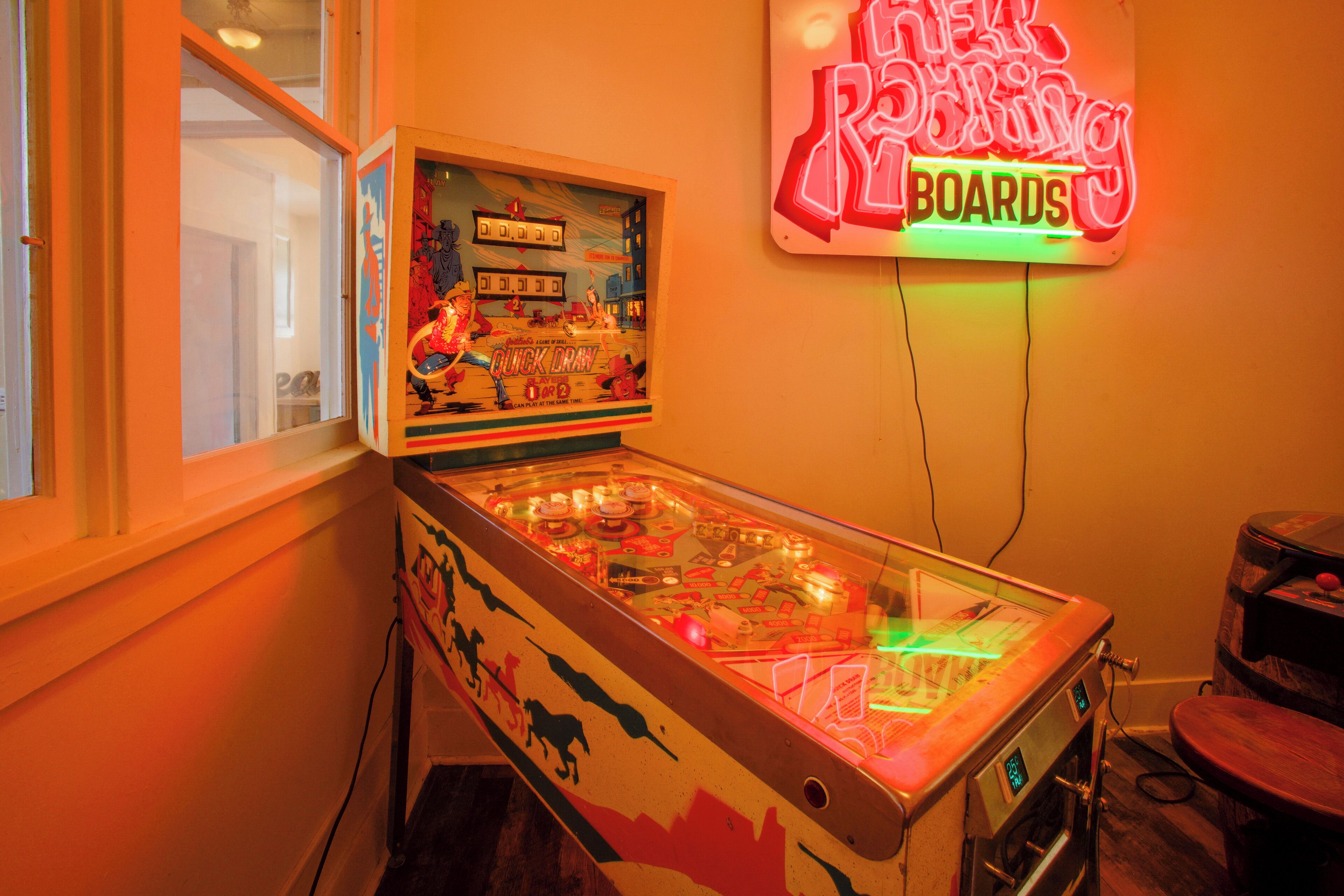 Een flipperspel met een neonreclame erboven.