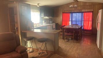 A compact living space with a kitchen, dining area, and a seating area.