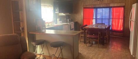A compact living space with a kitchen, dining area, and a seating area.