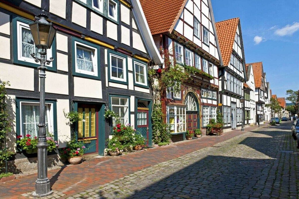 A traditional half-timbered building with a cobblestone street.
