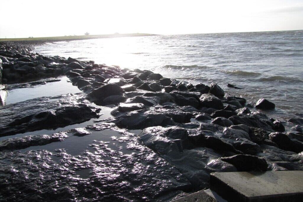 A rocky shoreline with waves crashing against the rocks.