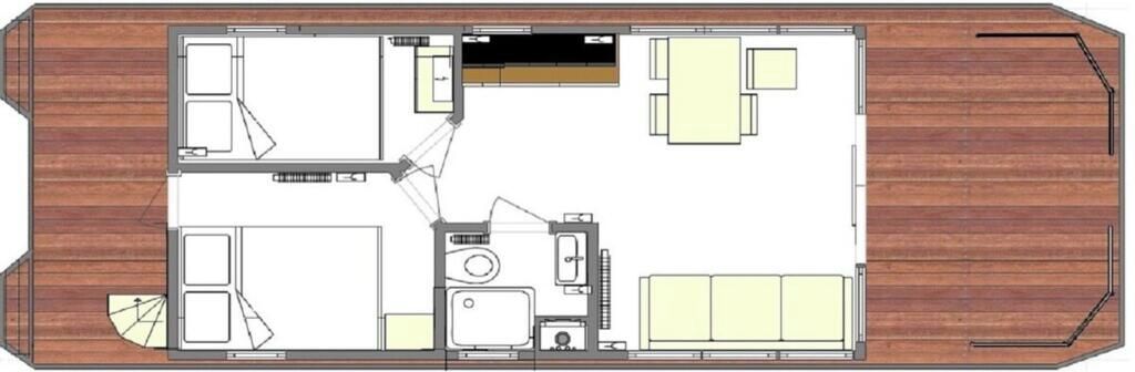 Ein Grundriss eines Hotels mit einer zentralen Halle, mehreren Schlafzimmern, einem Badezimmer und einem Essbereich.
