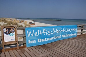 A wooden deck with a blue banner advertising a seafood festival. - Holiday apartment Ostseefee (Schönberger Strand)