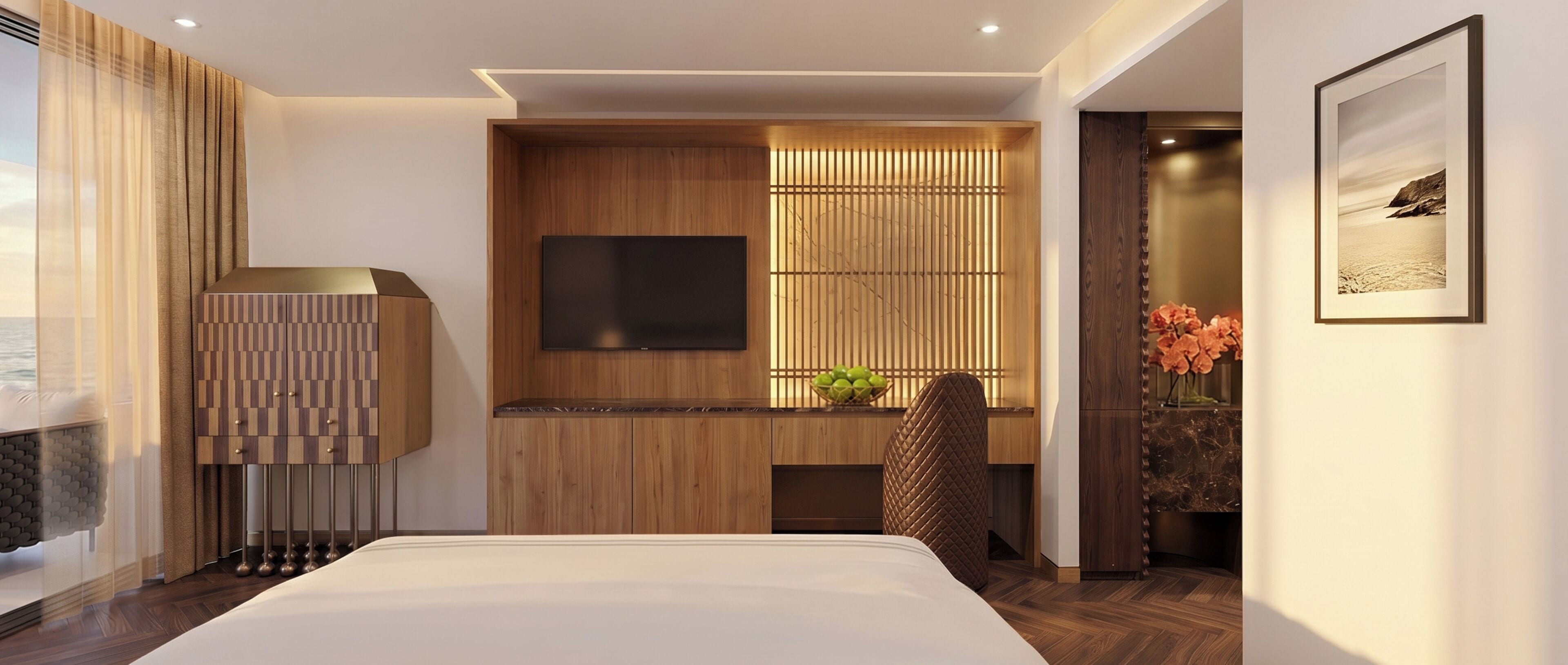 A modern hotel room with a bed, a TV, a wooden cabinet, and a view of the sea.