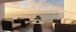 A balcony with two sofas and a bonsai tree, overlooking a body of water with sailboats. - O'Two Hotels - Mar (Cape Town)