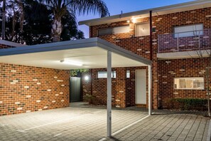 A two-story brick house with a covered driveway and a gated entrance. - Terra de Sol | Terracotta Courtyard, Swan Valley (Bassendean)
