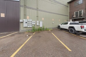 A parking lot with a white pickup truck parked on the right. - Bliss Retreat Whitefish Studio (Whitefish)