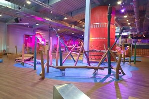 An indoor play area with various play structures and a large red cylindrical column. - Travemünde-Priwall - Anchorage (Lübeck Travemünde)