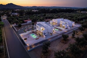 A modern villa with a swimming pool, multiple bedrooms, and a view of the surrounding landscape. - Villa located in Kolympia (Rhodes)