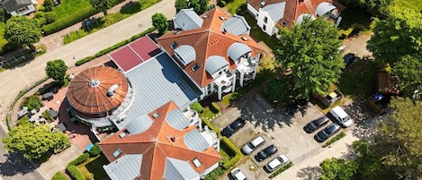 A residential area with multiple houses, a central building with a dome, and a parking area.