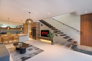 A modern interior with a kitchen, dining area, and living space. - Evita Villa by Betterplace (Canggu)