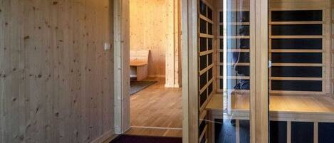 A wooden interior with a visible doorway leading to another room.