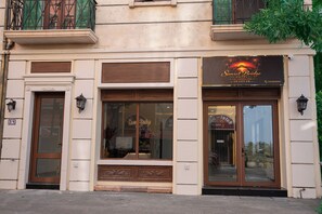 A hotel facade with a large sign, windows, and a door. - Sunset Bridge Hotel Phu Quoc (Phu Quoc)