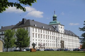 A large, historic building with a prominent tower and a central entrance. - Holiday home in Bohnert with swimming pool (Bohnert)