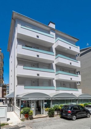 A multi-story building with a ground-level entrance labeled 'RESIDENCE MARZIA.' - Residence Marzia (Rivazzurra)