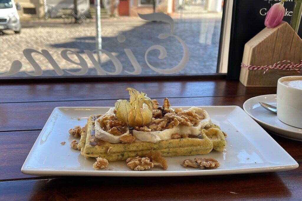A plate of food with a dessert on a table.