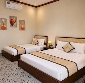 A hotel room with two beds, a wall-mounted air conditioner, and decorative wall art. - Tam Coc Amana Boutique Hotel (Nam Hoa Lu)