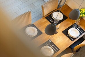 A dining table set with plates, cutlery, and a glass. - Holiday home in Bohnert with sauna (Bohnert)
