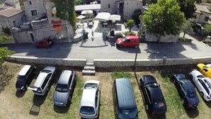 A parking lot with multiple cars and a building with a sign that reads 'Ristorante'. - Vrbo Property (Grospierres)