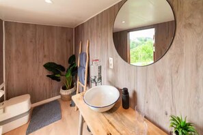 A bathroom with a wooden vanity, a large mirror, and a window. - Charming Couple Getaway in Bouillon (Bouillon)