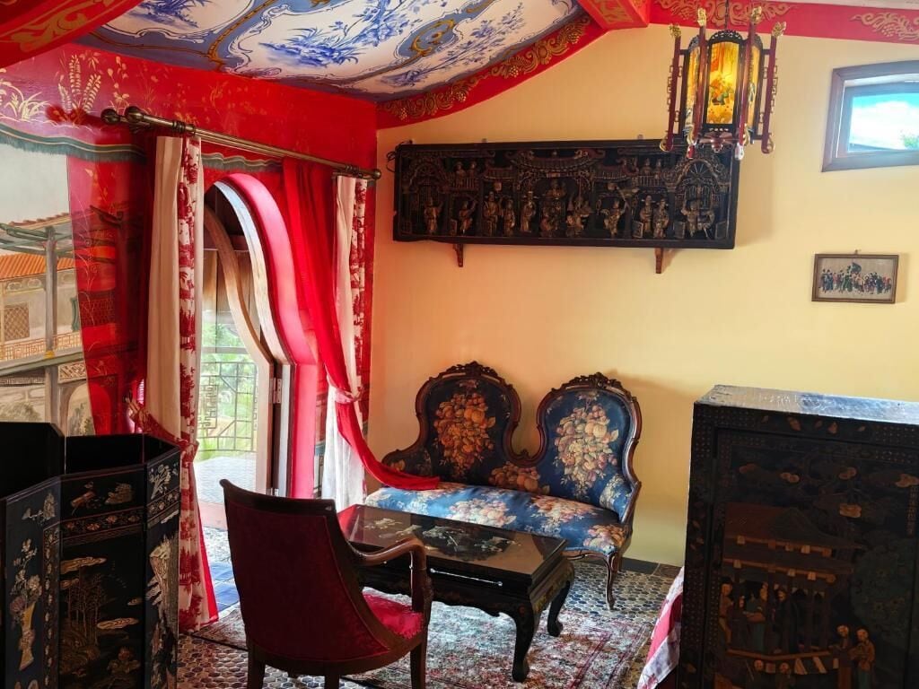 A traditional room with a sofa, a chair, a table, and a decorative wall piece.