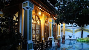 A traditional building with arched windows and a tiled floor. - Thien Y Villas (Phu Xuan)