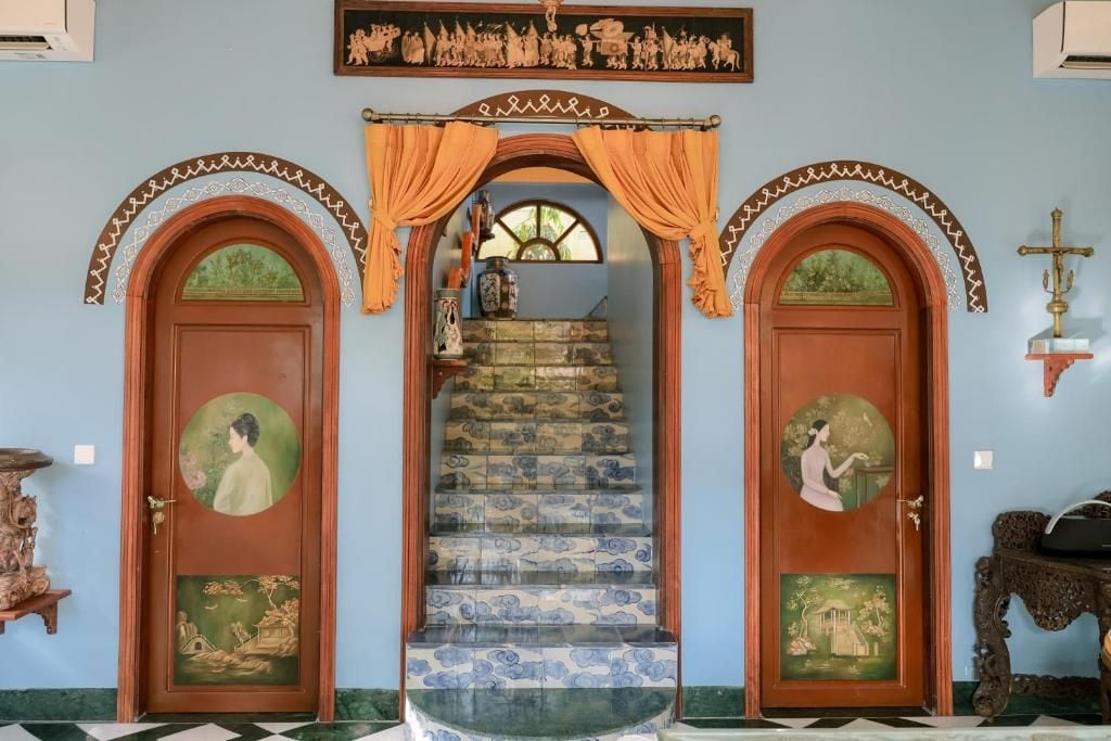 A staircase with ornate doors and a decorative ceiling.