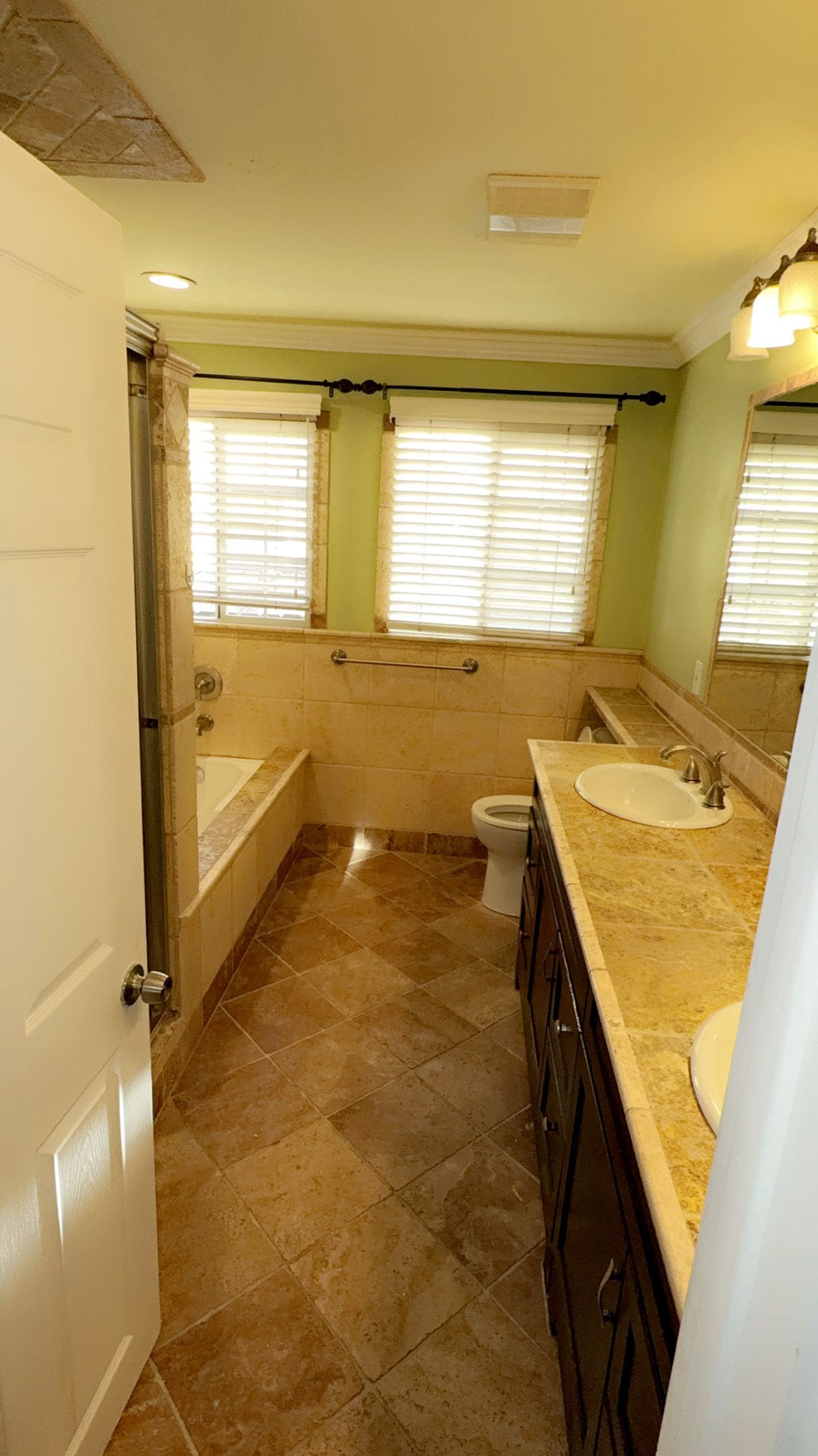 A bathroom with a bathtub, toilet, and sink.